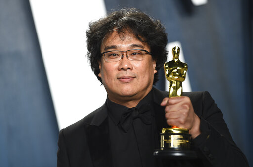 Bong Joon-ho, winner of the awards for best original screenplay, best international feature film, best directing, and best picture for "Parasite," arrives at the Vanity Fair Oscar Party on Sunday, Feb. 9, 2020, in Beverly Hills, Calif. (Photo by Evan Agostini/Invision/AP)