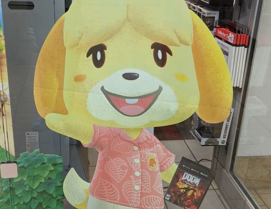 A humorous Gamestop display featuring Animal Crossing character Isabelle holding Doom Eternal.