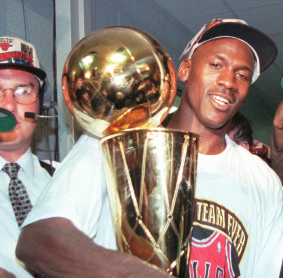 Chicago Bulls Michael Jordan holds the NBA Championship trophy after the Bulls beat the Seattle SuperSonics 87-75 Sunday, June 16, 1996, in Chicago to win their fourth NBA Championship. 