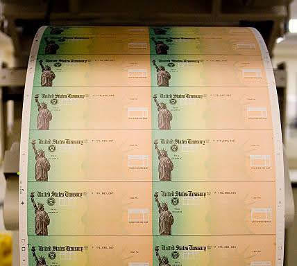 Photo courtesy of Jeff Fusco/Getty Images. Economic stimulus checks are prepared for printing at the Philadelphia Financial Center May 8, 2008 in Philadelphia, Penn.