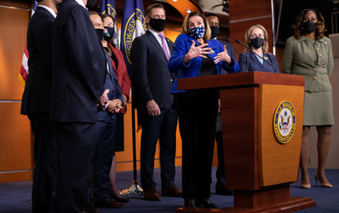 Photo courtesy of Graeme Sloan/Bloomberg at Getty Images. U.S. House Speaker Nancy Pelosi, a Democrat from California, center, wears a protective mask while speaking during a news conference with House impeachment managers at the U.S. Capitol in Washington, D.C., U.S., on Saturday, Feb. 13, 2021.  