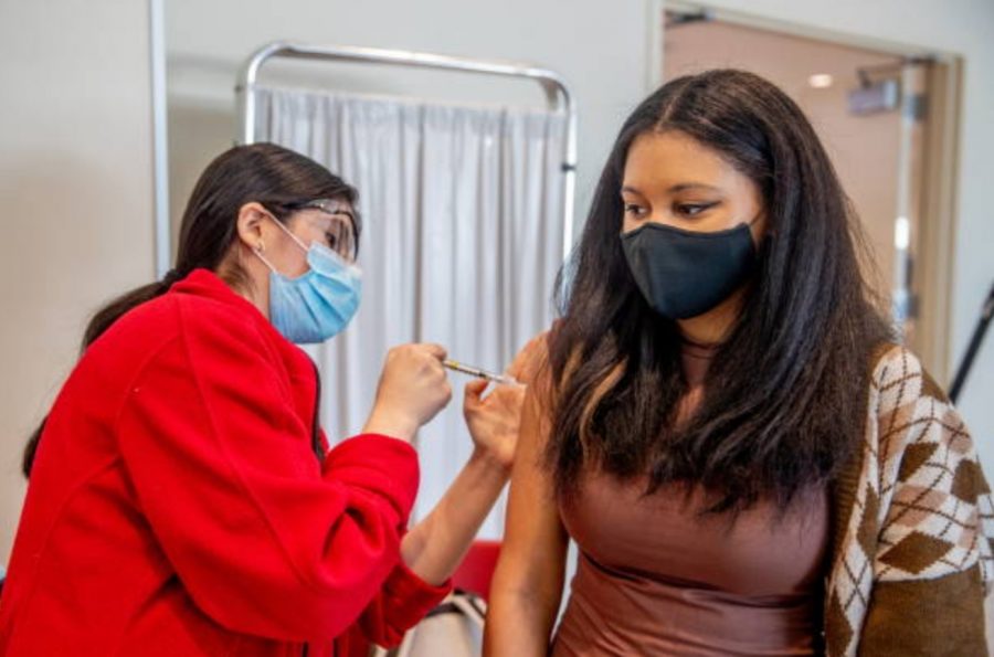 Photo courtesy of Getty Images/Raychel Brightman. Student recieves her first Moderna COVID-19 vaccine at Stony Brook University on April 6, 2021.
