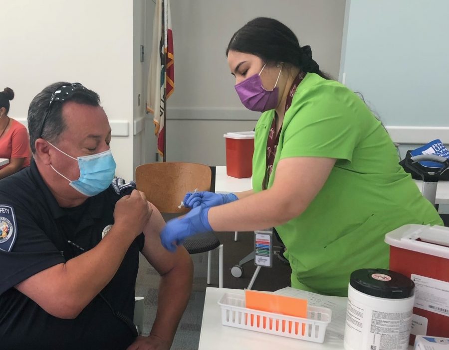 Photo courtesy of College of The Desert. Public Safety officer, Robert Perez receiving the COVID-19 vaccine.