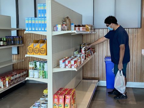 Photo courtesy of Cindy Chavez. Student David Perez shops through the Indio campus market shelves, full of cans, nonperishables, produce and snacks.