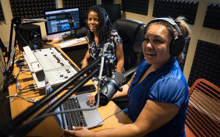 Photo courtesy of Andrew Allan-Bentley. Martha Hackett, student production manager (left) and Linda Luna, student intern (right) create new holidays sweepers for COD Roadrunner Radio.