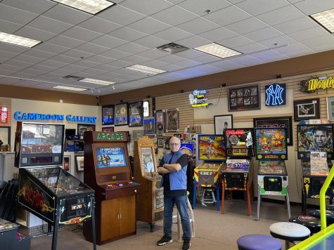 Photo Courtesy of The Chaparral. Michael Lansing, owner of Gameroom Gallery, stands tall in his store. 