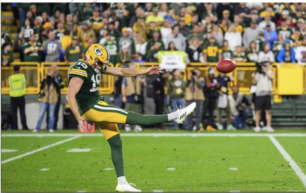 Photo courtesy of Getty Images/Cooper Neill Daniel Whelan #19 of the Green Bay Packers punts the ball during at Lambeau Field on September 28, 2023 in Green Bay, Wisconsin. 
