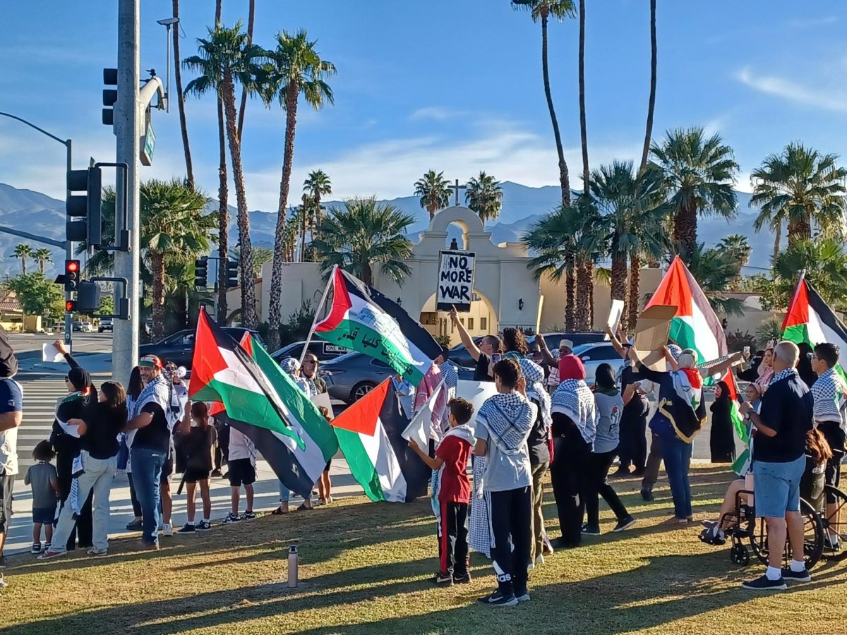 Photo courtesy of the Chaparral/Christopher Gonzalez. Pro-Palestinian activists line Fred Waring across the street from Palm Desert Civic Park. 
