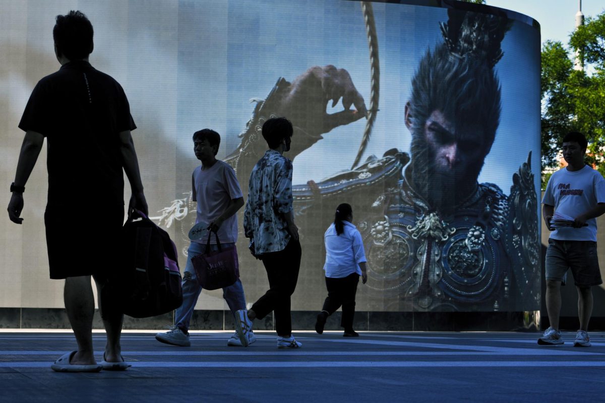 Photo courtesy of AP images/Andy Wong.
People walk past a screen promoting an advertisement of the latest blockbuster new Chinese video game "Black Myth: Wukong" outside a commercial office building in Beijing, Tuesday, Aug. 27, 2024.