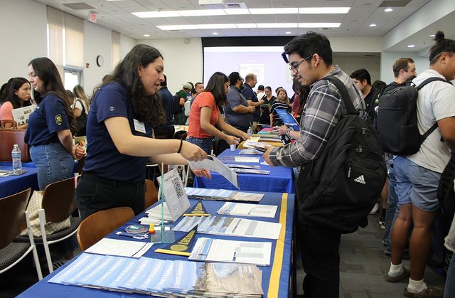 Prospective students getting information from university admission advisers. 
Photo courtesy of College of the Desert.