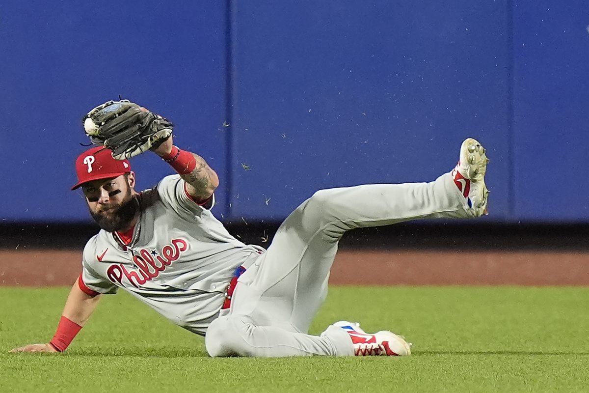 Philadelphia Phillies outfielder Weston Wilson makes a sliding catch on a ball hit by New York Mets' Francisco Lindor during the eighth inning of Game 4 of the National League baseball playoff series, Wednesday, Oct. 9, 2024, in New York. (AP Photo/Frank Franklin II)