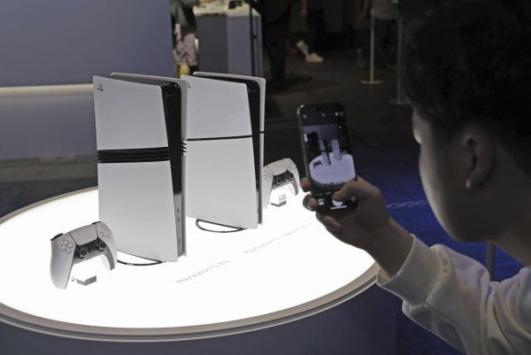 Courtesy of AP Images. A visitor takes a photo of Sony Interactive Entertainment Inc.'s latest PlayStation 5 Pro console at the Tokyo Game Show at Makuhari Messe convention center in Chiba, near Tokyo, on the opening day of the four-day event on Sept. 26, 2024.