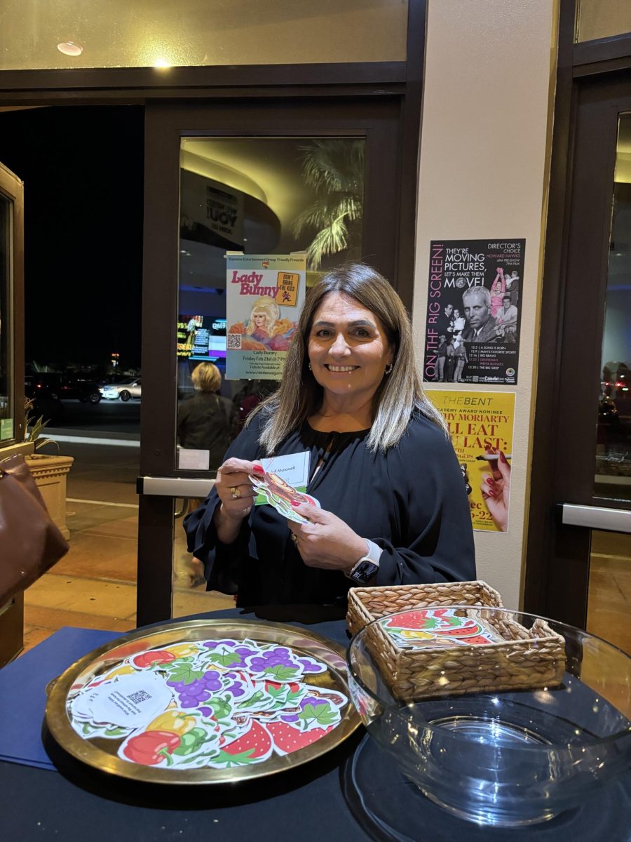 Photo courtesy of The Chaparral/Layla Freiberg. Scholarship Administrative Specialist for the College of the Desert Foundation, Juli Maxwell, handing out stickers of fruits grown/picked in the valley after the showing. 