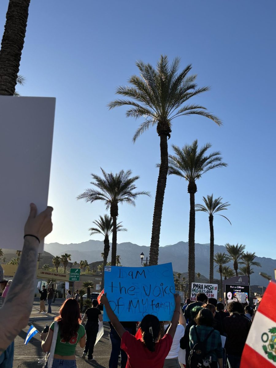 Photo courtesy of The Chaparral/Layla Freiberg. A protestor in Cathedral City holds a sign that reads "I am the voice of my family." 