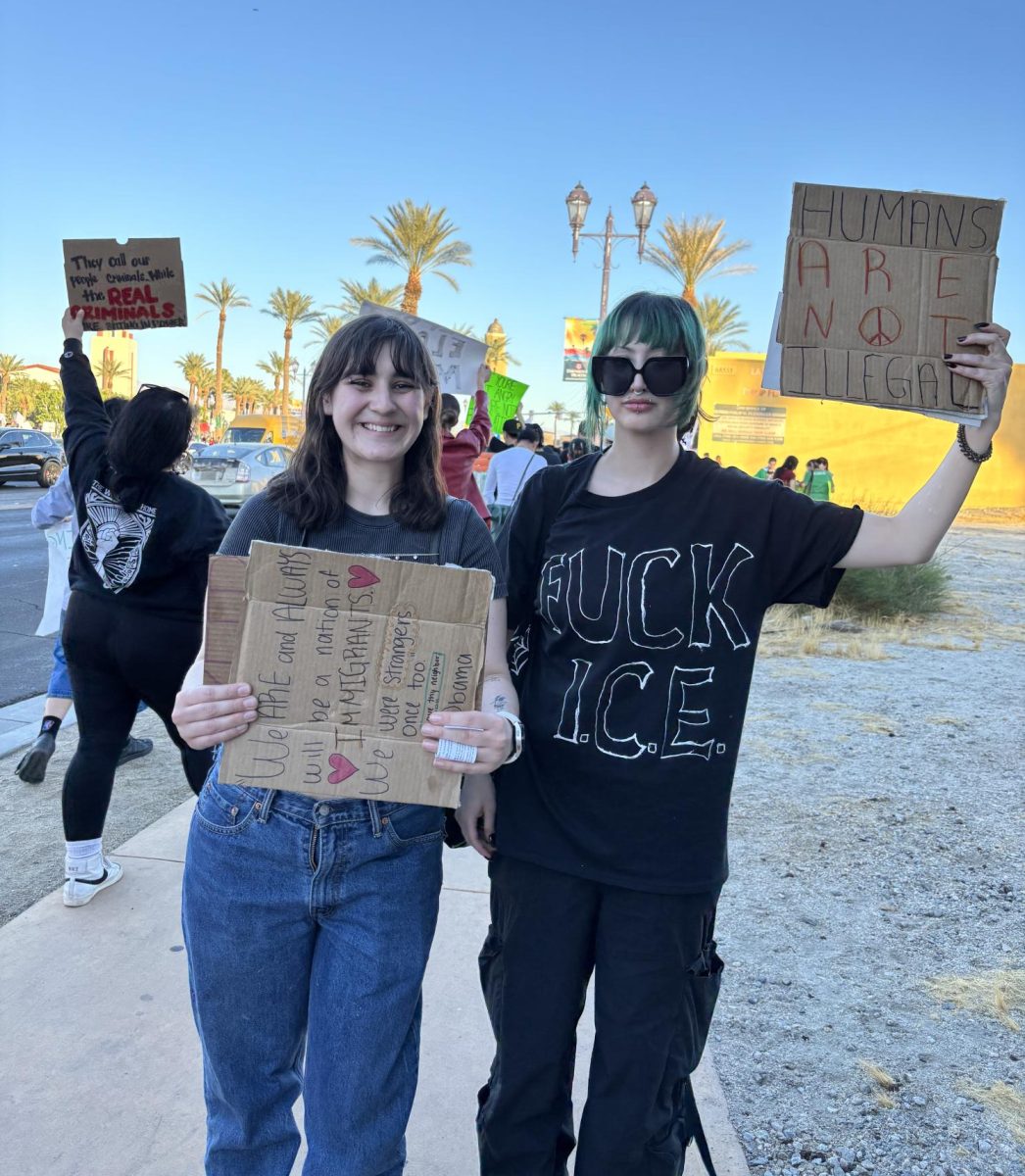 Photo courtesy of The Chaparral/Layla Freiberg. Brooklyn Ruth and her friend pose with their signs at the Cathedral City protest. 