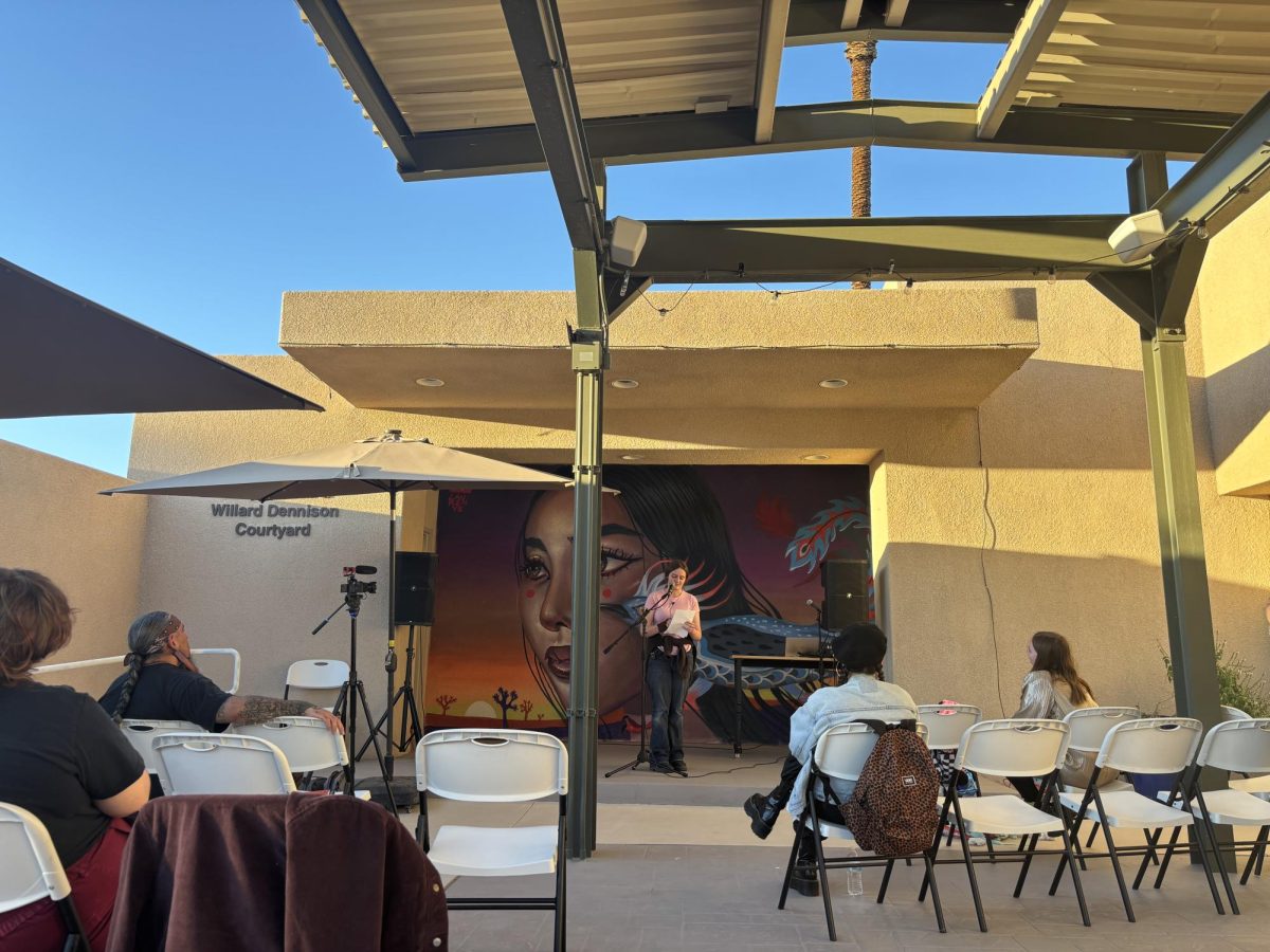 Photo courtesy of the Chapparal/Layla Freiberg. Anastasia reciting her sister Abby's poem at the open mic night. 