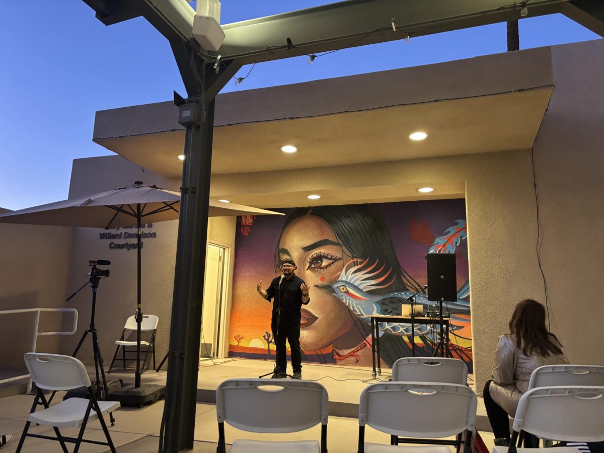 Photo courtesy of The Chapparal/Layla Freiberg. Arturo Castellanos of Props2Poetry reciting his poem at the open mic night. 