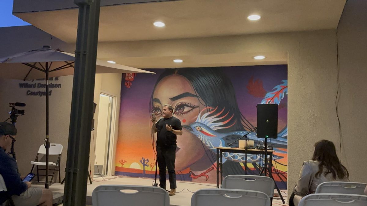 Photo courtesy of The Chapparal/Layla Freiberg. Mario Francisco Regalado-Sanchez reciting his poem at the open mic night. 