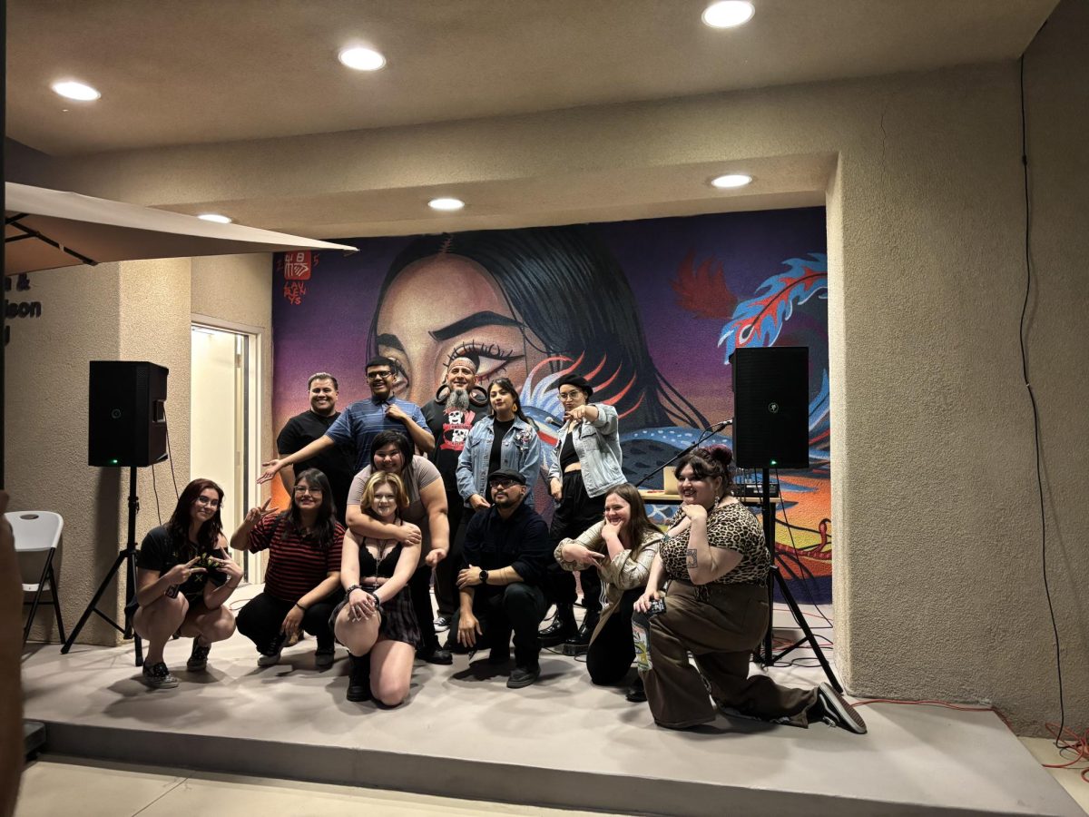 Photo courtesy of The Chapparal/Layla Freiberg. Performers at the open mic night gather at the end of the event for a group photo. 