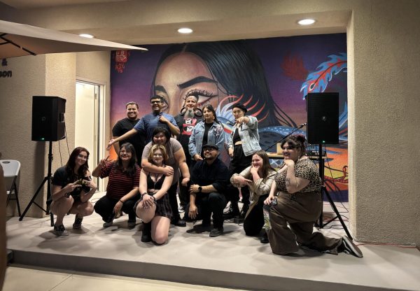 Photo courtesy of The Chapparal/Layla Freiberg. Performers at the open mic night gather at the end of the event for a group photo. 