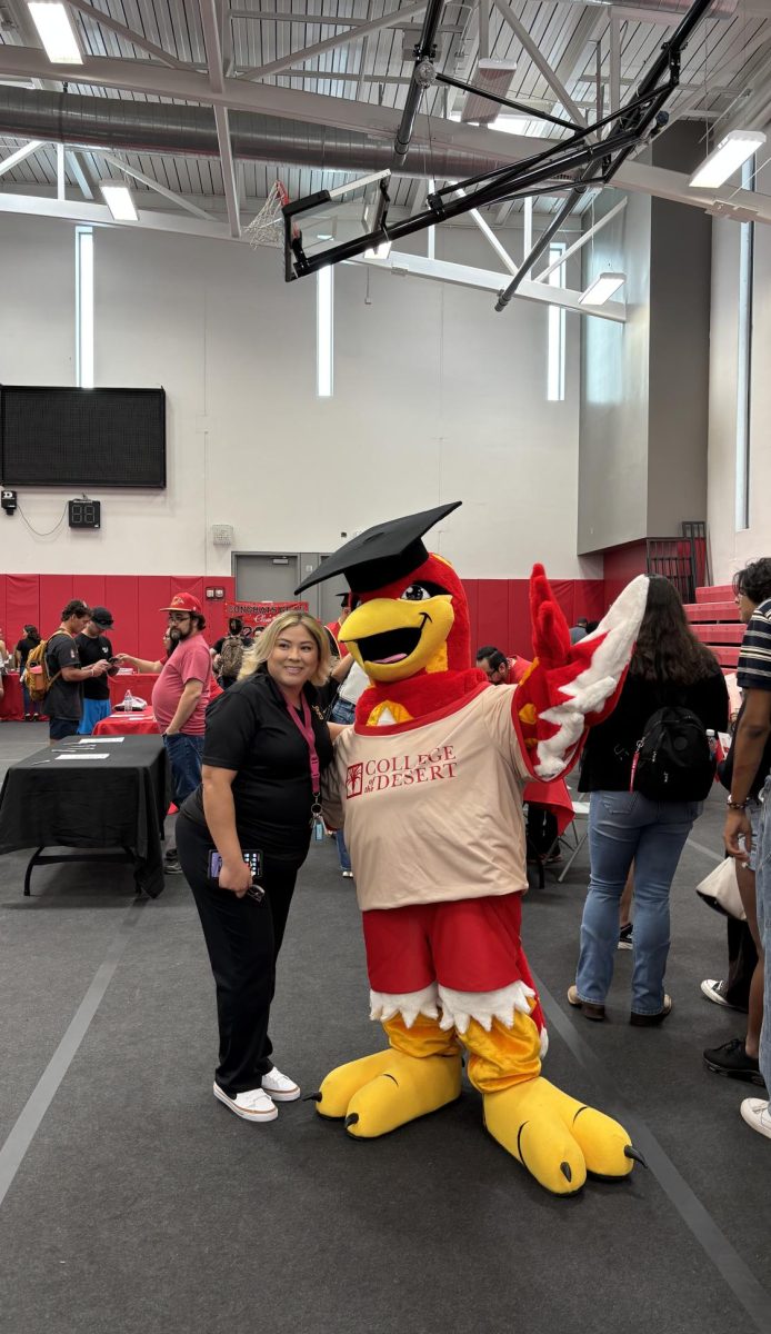 Photo courtesy of The Chaparral/Layla Freiberg. Rodney the Roadrunner poses with a COD staff member. 