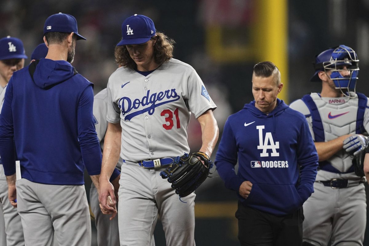 Photo courtesy of AP Images/Tony Gutierrez. Los Angeles Dodgers starting pitcher Tyler Glasnow (31) leaves the mound followed by a team staff member after suffering an unknown injury in the fifth inning of a baseball game against the Texas Rangers in Arlington, Texas, April 20, 2025. 


