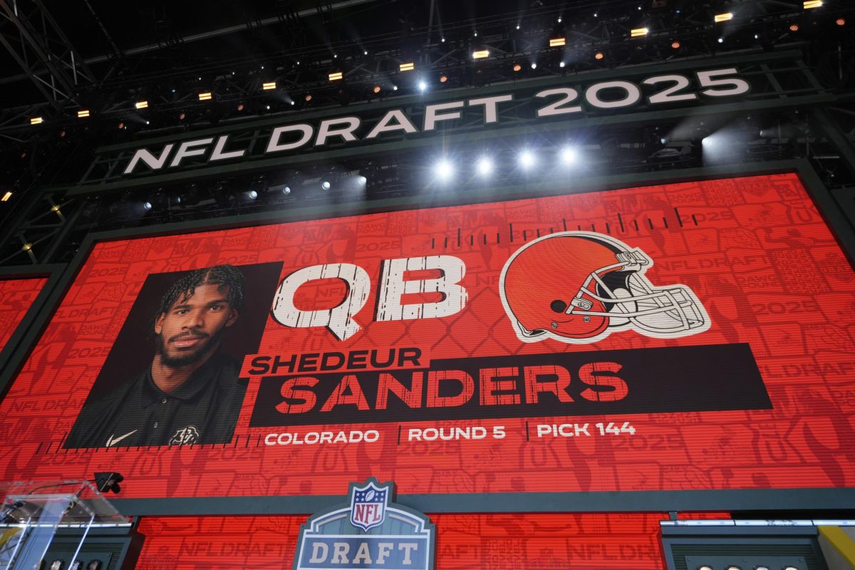 Photo courtesy of (AP Photo/Jeff Roberson). A graphic is shown after the Cleveland Browns select Shedeur Sanders in round 5 on Day 3 of the 2025 NFL Draft on Saturday, April 26, 2025 in Green Bay. 