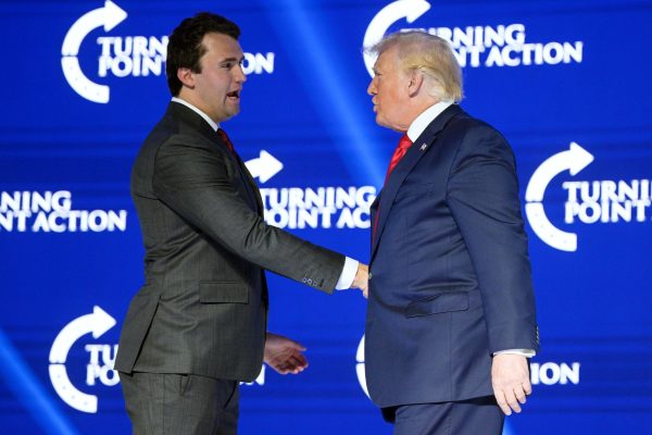 Photo courtesy of AP/Phelan M. Ebenhack, File – Former President Donald Trump, right, shakes hands with Turning Point CEO Charlie Kirk before speaking at the Turning Point USA Student Action Summit on July 23, 2022, in Tampa, Fla. The Nebraska Republican Party, led by Trump loyalists, will hold a rally on Tuesday, April 9, 2024, in Omaha, featuring Kirk to address the state’s system of splitting its five presidential electoral votes by congressional district.