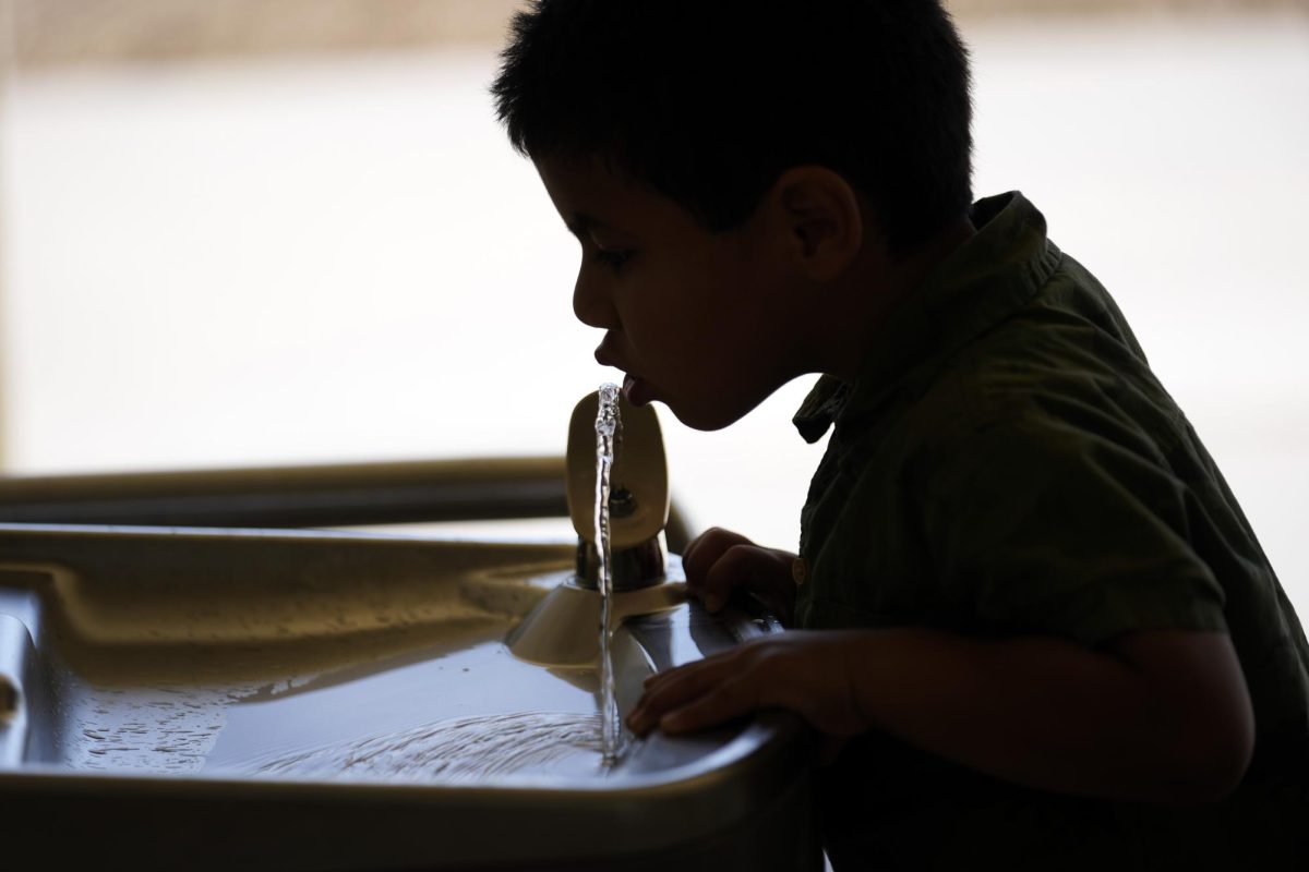 Child drinking from water fountain