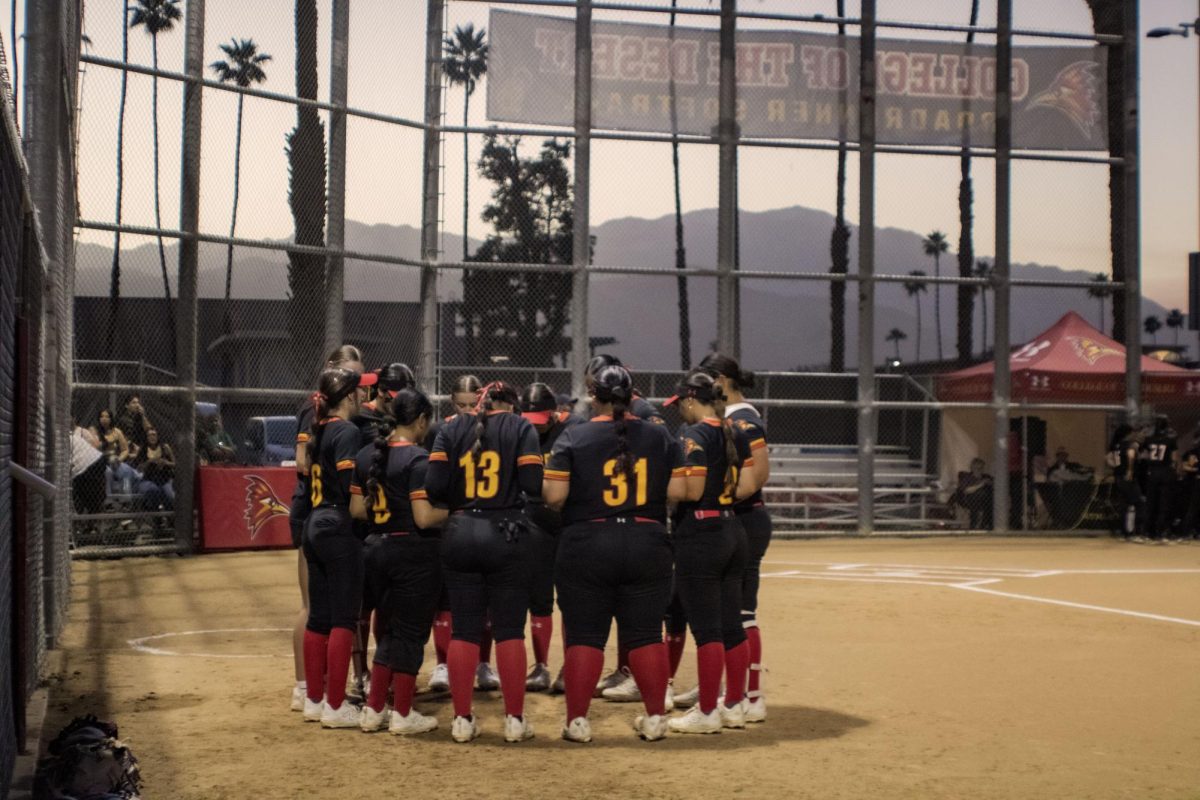 Photo Courtesy of The Chaparral/Tayler Vasquez. Cod Softball players preparing for their home game on February 25 with a prayer.