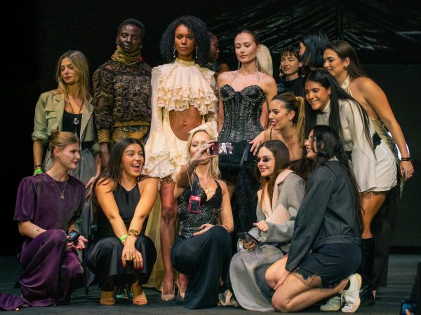 Photo Courtesy of The Chaparral/Kailey Diaz. Fashion Week models posing for photos after the runway show.