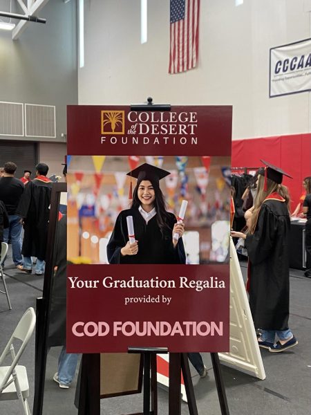 Photo courtesy of The Chaparral/Isabel Colin. Graduation regalia sign at GradFest. 